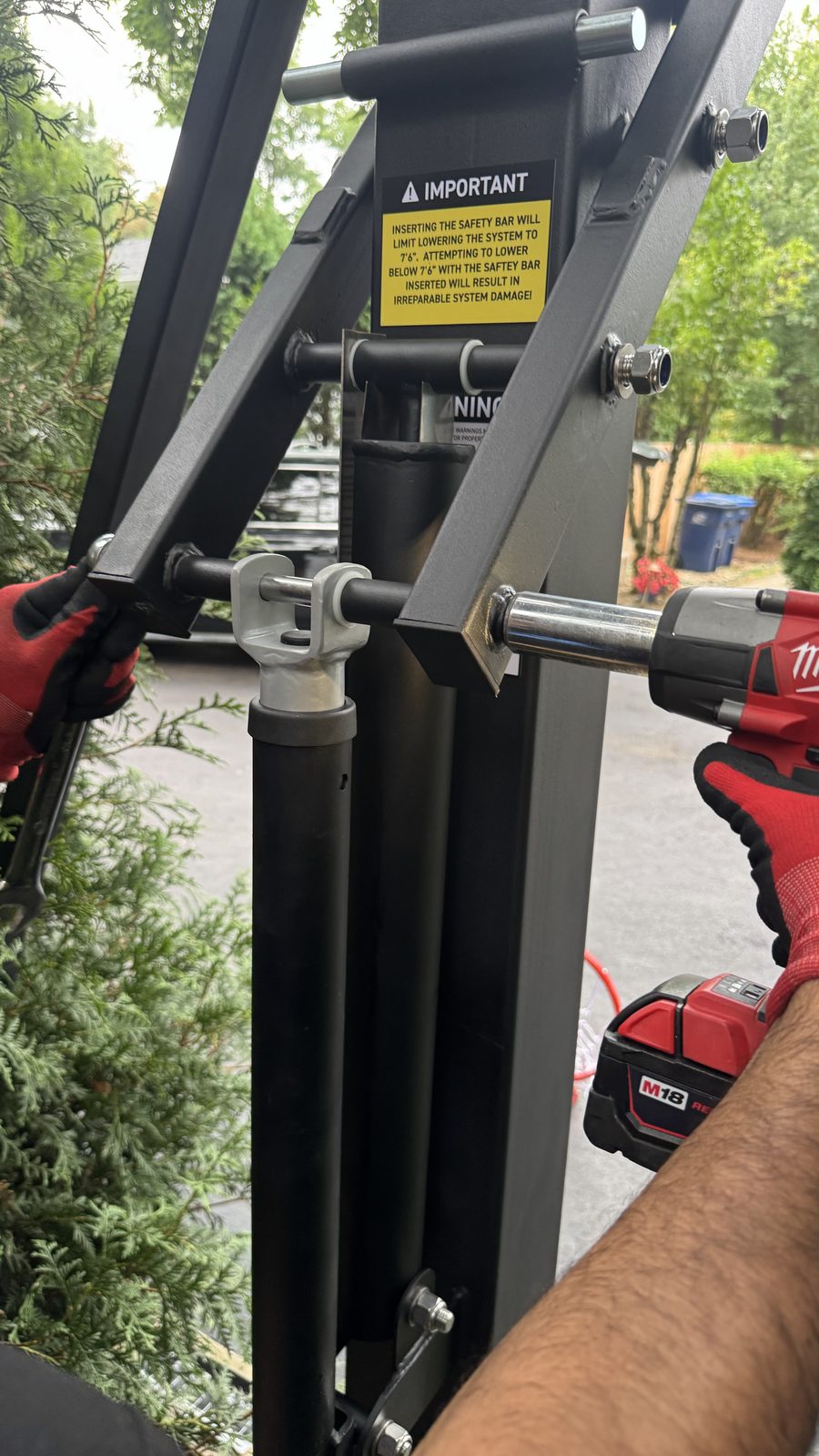Torquing the safety bar hardware on a hoop system with an impact wrench