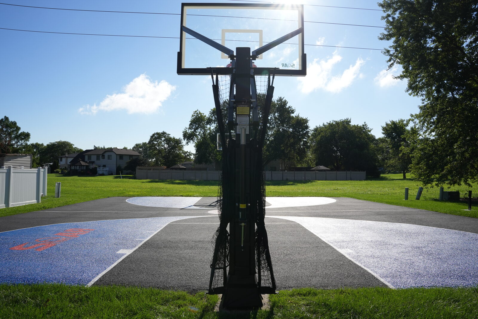 Backboard photographed with the sun directly behind it, showing how low sun creates glare for a shooter