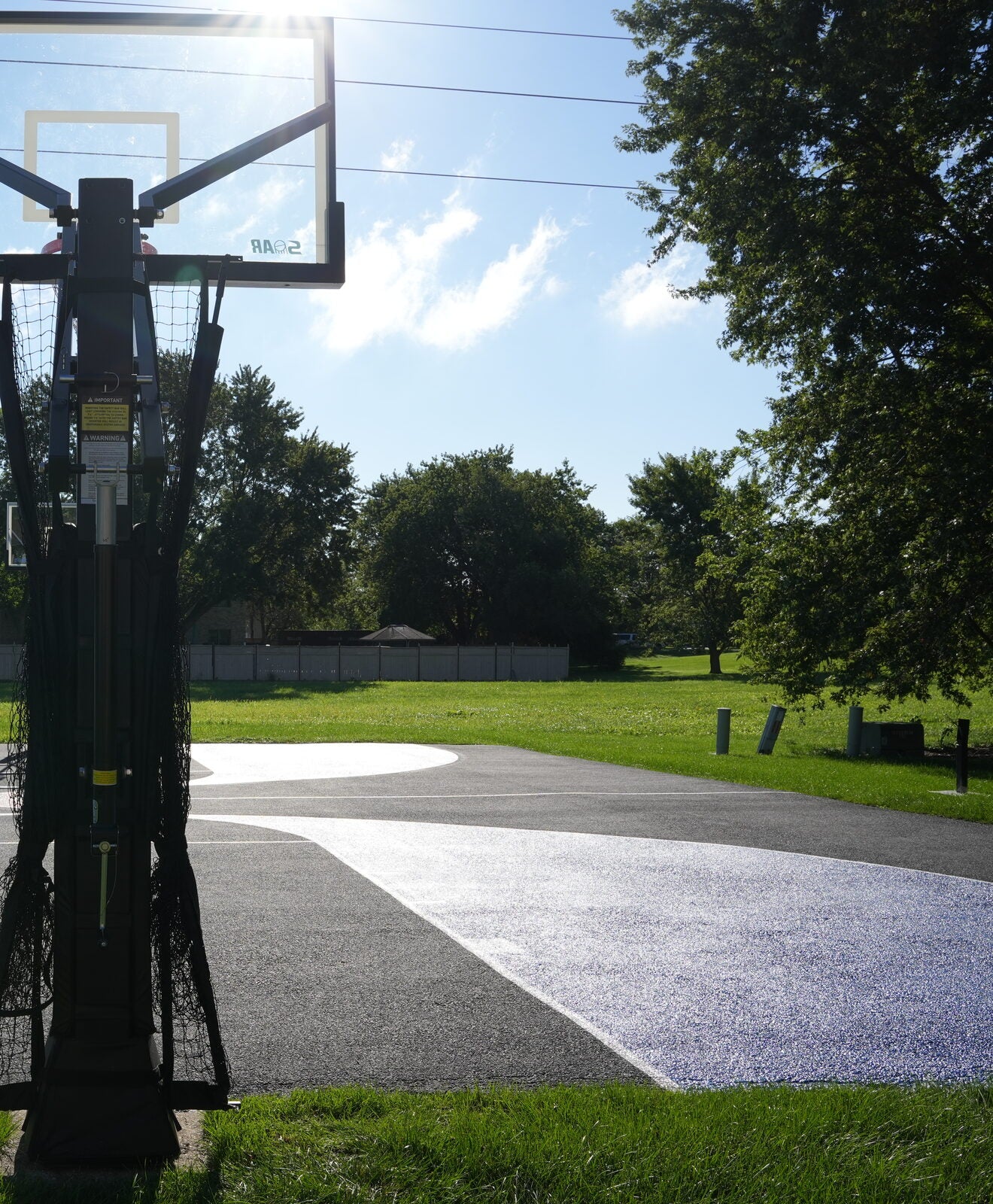 Finished residential basketball court surface with painted key and three-point arc
