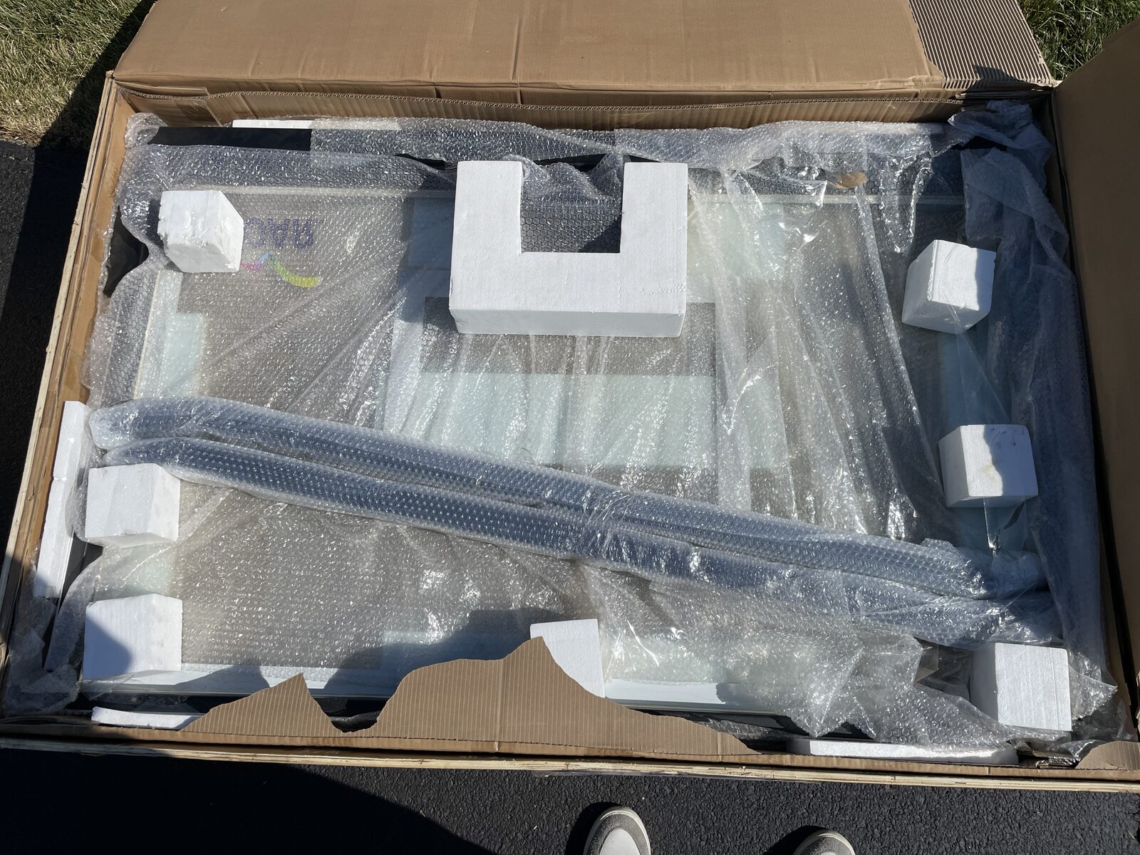 Tempered glass basketball backboard packaged for delivery on a truck